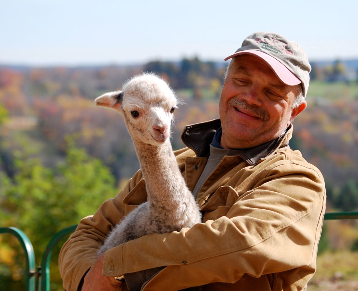 Rob with cria at Rosehaven Alpacas Inc